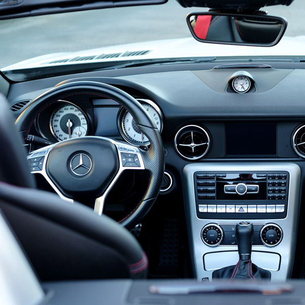 A car dashboard view from the rear seats, in a left hand drive Mercedes [do not use as thumbnail]